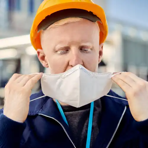 Worker putting on Respiratory Protection